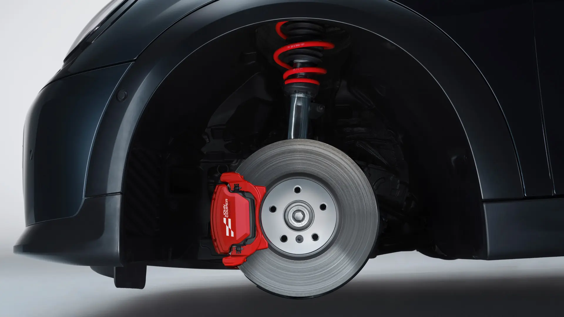 MINI John Cooper Works sport suspension with springs in John Cooper Works Chili Red.