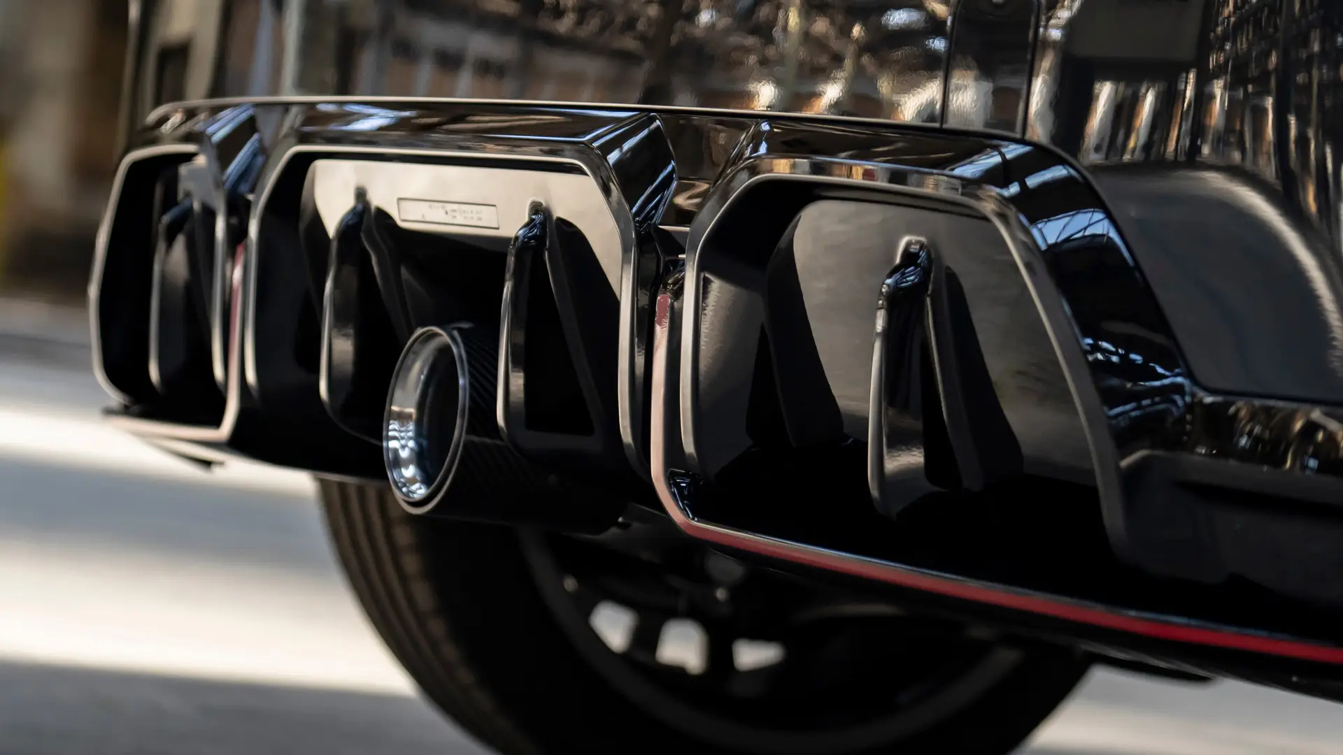 MINI John Cooper Works rear diffuser in black high gloss with red frame.