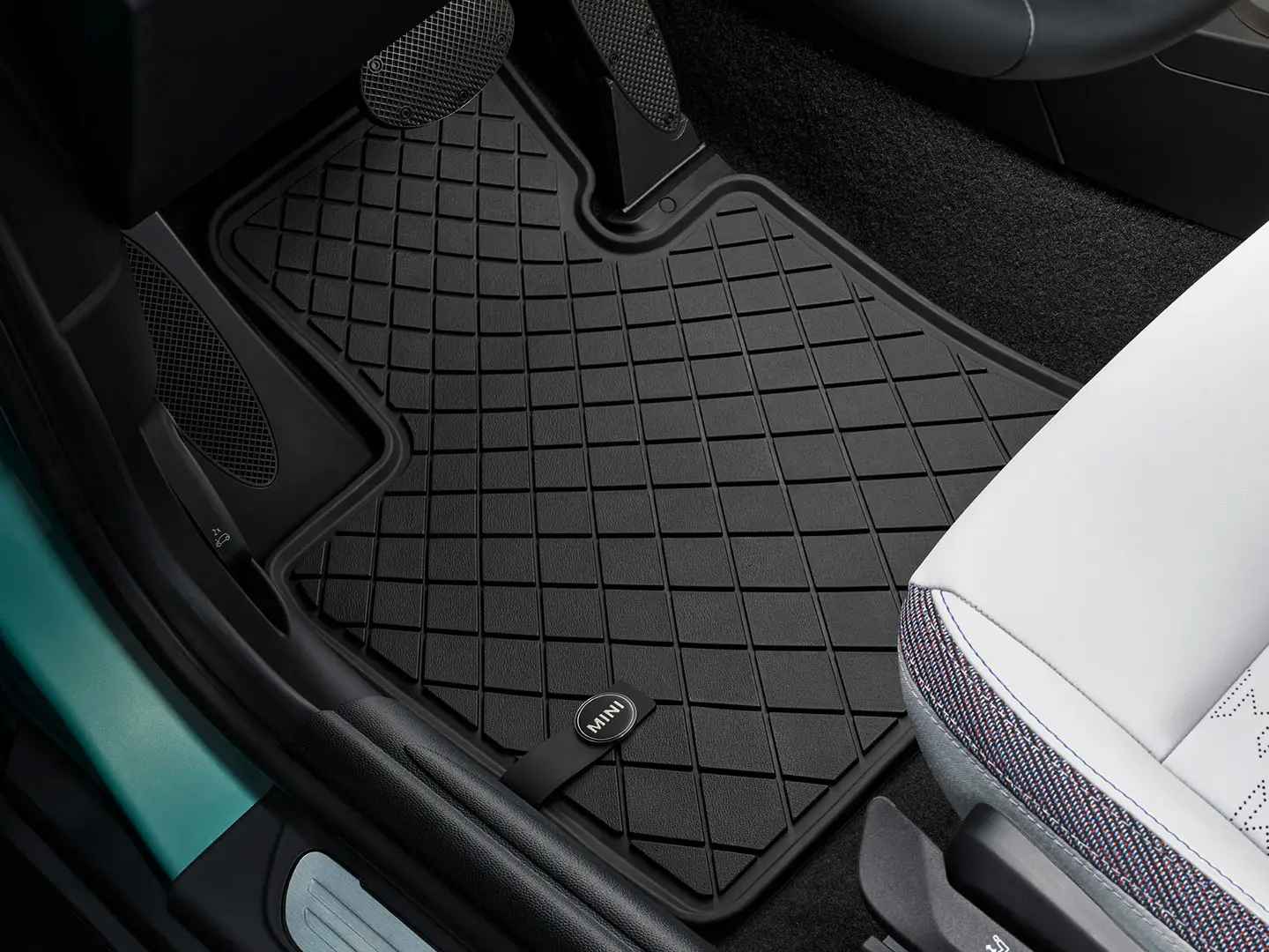 Standard MINI floor mat in footwell.