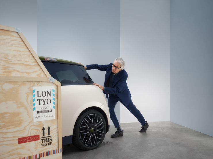 Back view of the all-electric MINI Cooper Paul Smith Edition in Inspired White with Paul Smith behind the car